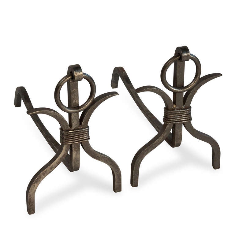 Pair of andirons, curved legs on either side, a central column, all joined by a wrapped central element, with suspended ring at the top, French 1950s. Height 12 in, width 7 1/2 in, depth 15 1/4 in. (Item #1792)
