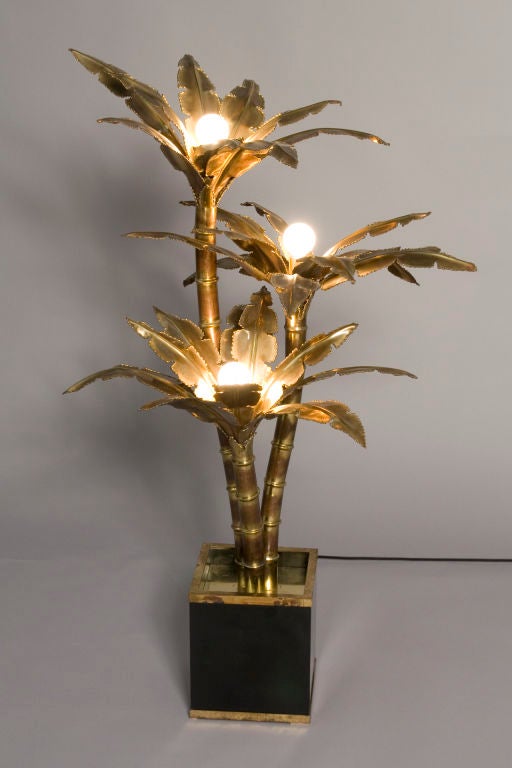 Three branch tree form brass floor lamp, each branch housing a light, mounted on a black metal square base, by Maison Jansen, and attributed to Willy Rizzo, French early 1970s. Height 43 in, largest diameter of leaves 25 in, base is 8 1/8 in square.