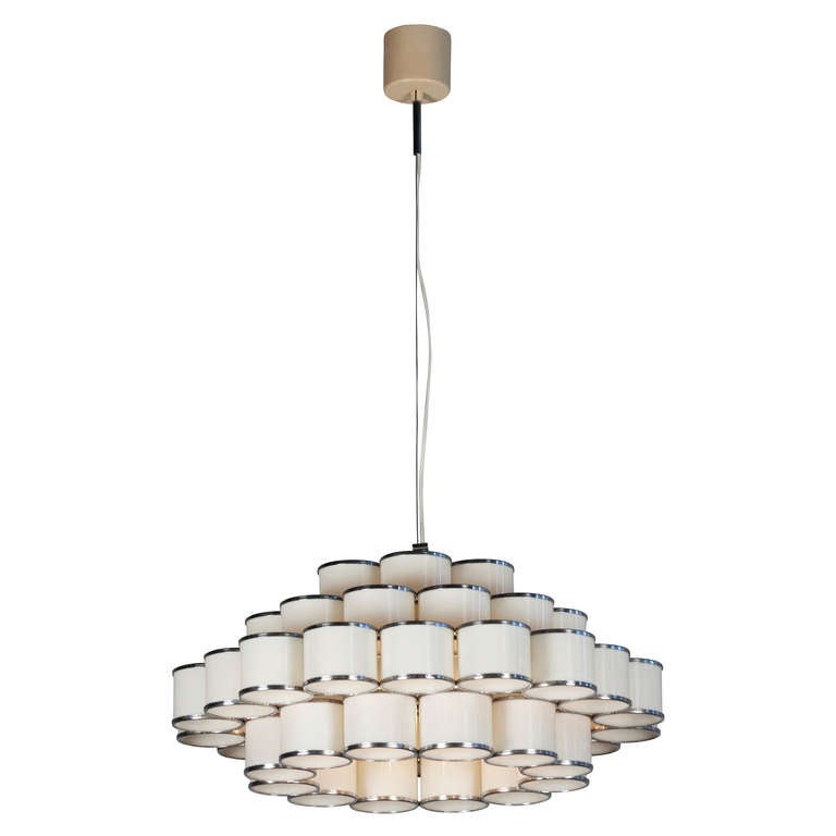 Chrome and white plexi circular chandelier composed of four graduated tiers of cylinders. Italian 1960s. Diameter 21 in, height of fixture 16 in. Overall height can be adjusted by modifying the length of the wire and cable.