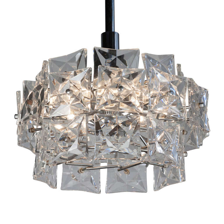 Faceted crystal wall chandelier, of overall circular form, square form crystal elements arranged in three tiers, and mounted to a chrome fixture,by Kinkeldey, Austrian,1960s. Height 17 1/2 in. diameter 17 in. (Item #2040)