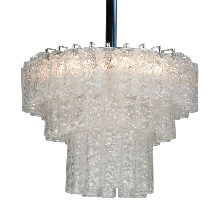 Three tier textured glass chandelier, three rings of glass cylinders suspended from a chrome fixture, by Doria, Germany 1960s. Overall height 37 in, height of fixture 12 in, largest diameter 16 in. (Item #2041)