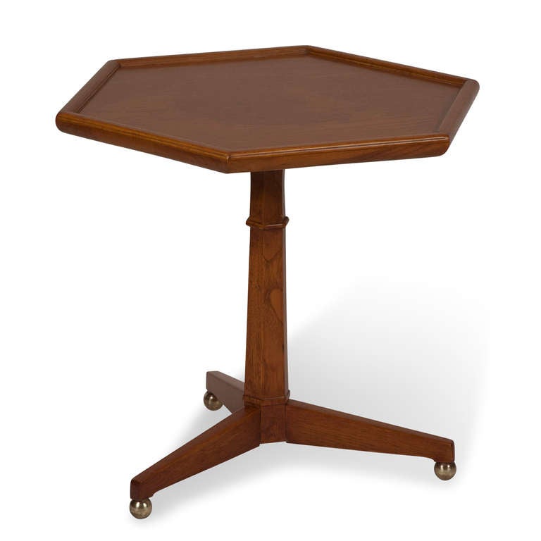 Oak hexagon table, the top surface with center burl ring, mounted on thee legs, with brass ball feet, by Henredon, American circa 1960. Height  17 in, width across top, from side to side 17 in. (Item #2050)