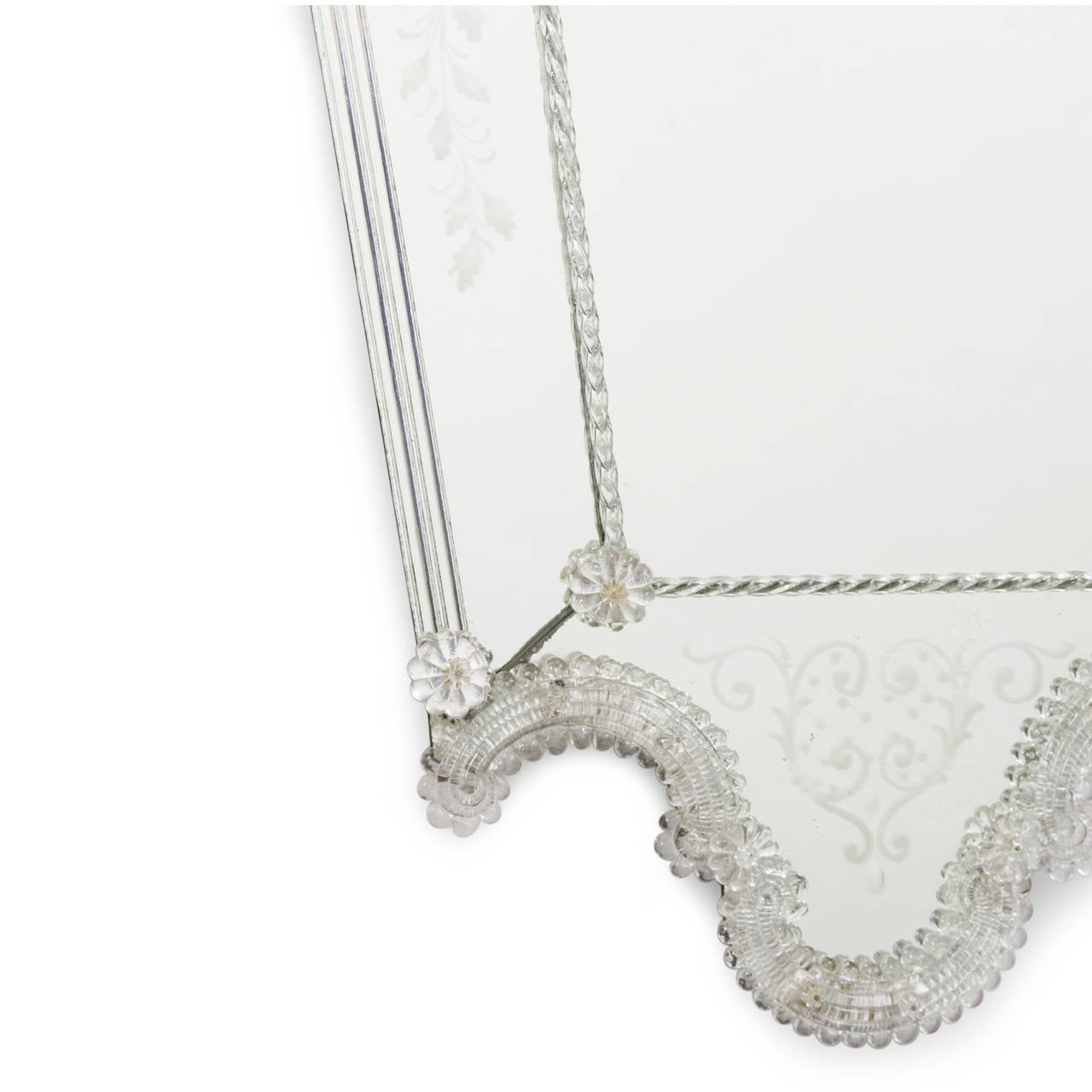 Clear and silvered glass frame mirror, with glass florets applied to braided rope form frame, outer panels etched with foliate decoration, central panel having smaller rope border and florets at each corner, the overall shape an V-Form with rounded