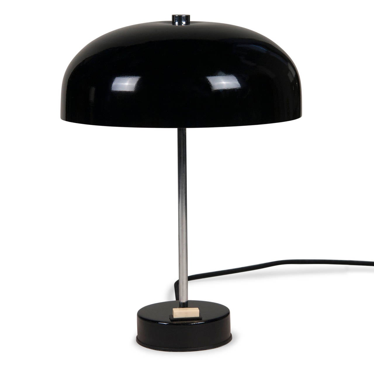Black lacquered desk lamp, lacquered dome shade mounted on a thin chrome column, with a disc shaped circular base, original toggle switch, German, circa 1970. Overall height 14 in, diameter of shade 10 in, height of shade 4 in, base measures 4 in