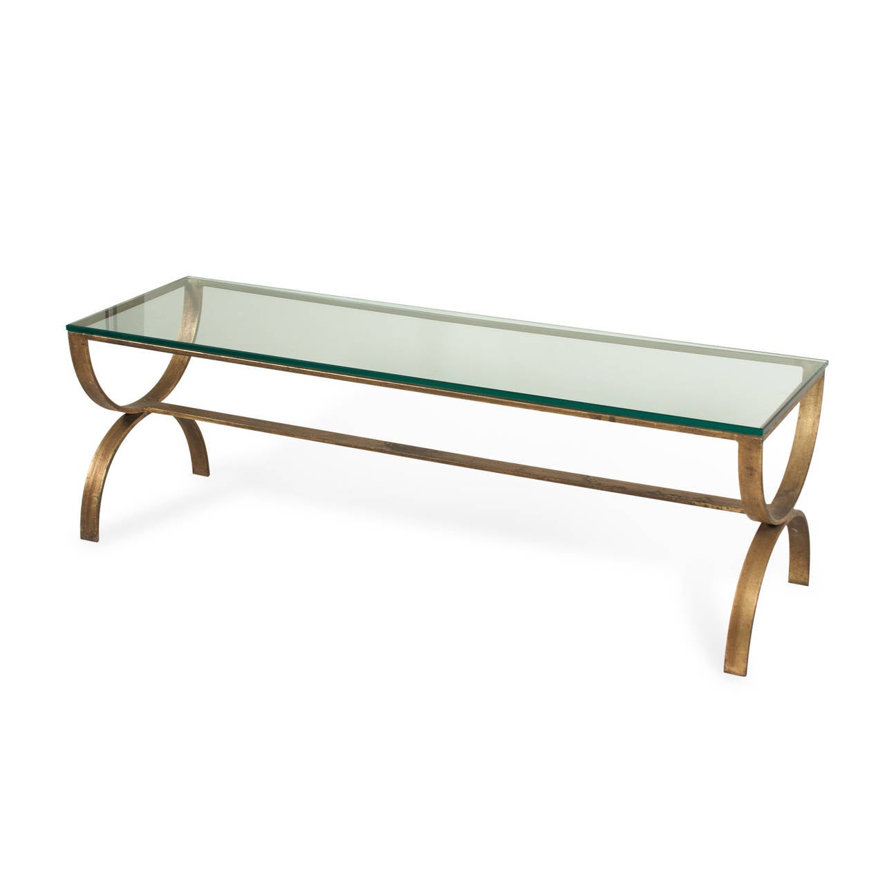 Gilt steel rectangular coffee table, double-U shaped ends with center stretcher, clear glass top, American, circa 1980. Dimensions: Length 50 in, width 15 1/2 in, height 16 1/4 in. (Item #2280)