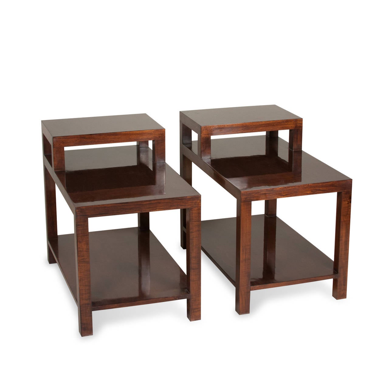 Pair of teak stepped end tables, the legs and supports of squared wooden form, and having lower shelf, by T. H. Robsjohn-Gibbings for Widdicomb, American, 1950s. Measures: 30 in x 18 in, height in back 24 1/2 in, height in front 19 1/2 in. (Item
