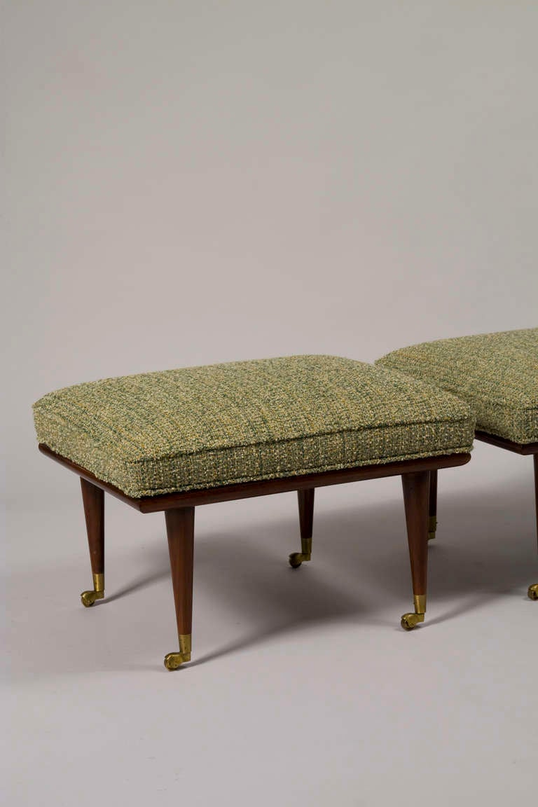 Pair of mahogany four leg upholstered footstools, the tapered legs on casters with bronze sabots, by Widdicomb, American 1950s. 24 1/2 in. x 20 in, height 16 1/2 in. (Item #1714)
