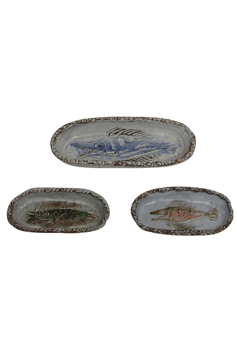Set of three oval ceramic bowls, with high rim, and interior fish decoration, hand built and decorated, by Albert Thiry, French 1960s. Largest measures 11 3/4 in x 4 3/4 in, the smaller two 7 3/4 in x 3 7/8 in. (Item #1194)