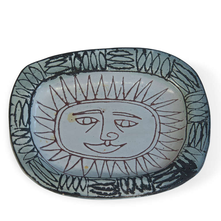 Sun-face ceramic dish, with abstract leaf border, by Jacques Pouchain, French 1950s. 7 1/2 in x 6 in, height 1 in. (Item #1831)
