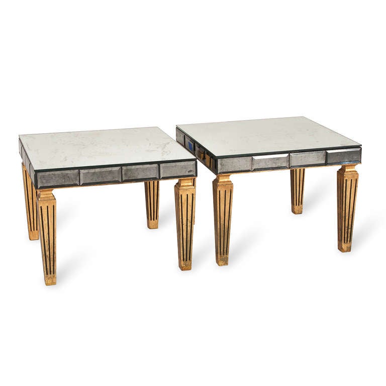 Pair of antiqued mirror top end tables, with mirrored faceted side border, on four gilt wood tapered and fluted legs, by Grosfeld House, American 1940s. 20 in square, height 15 1/4 in. (Item #2002)
Price for the pair.