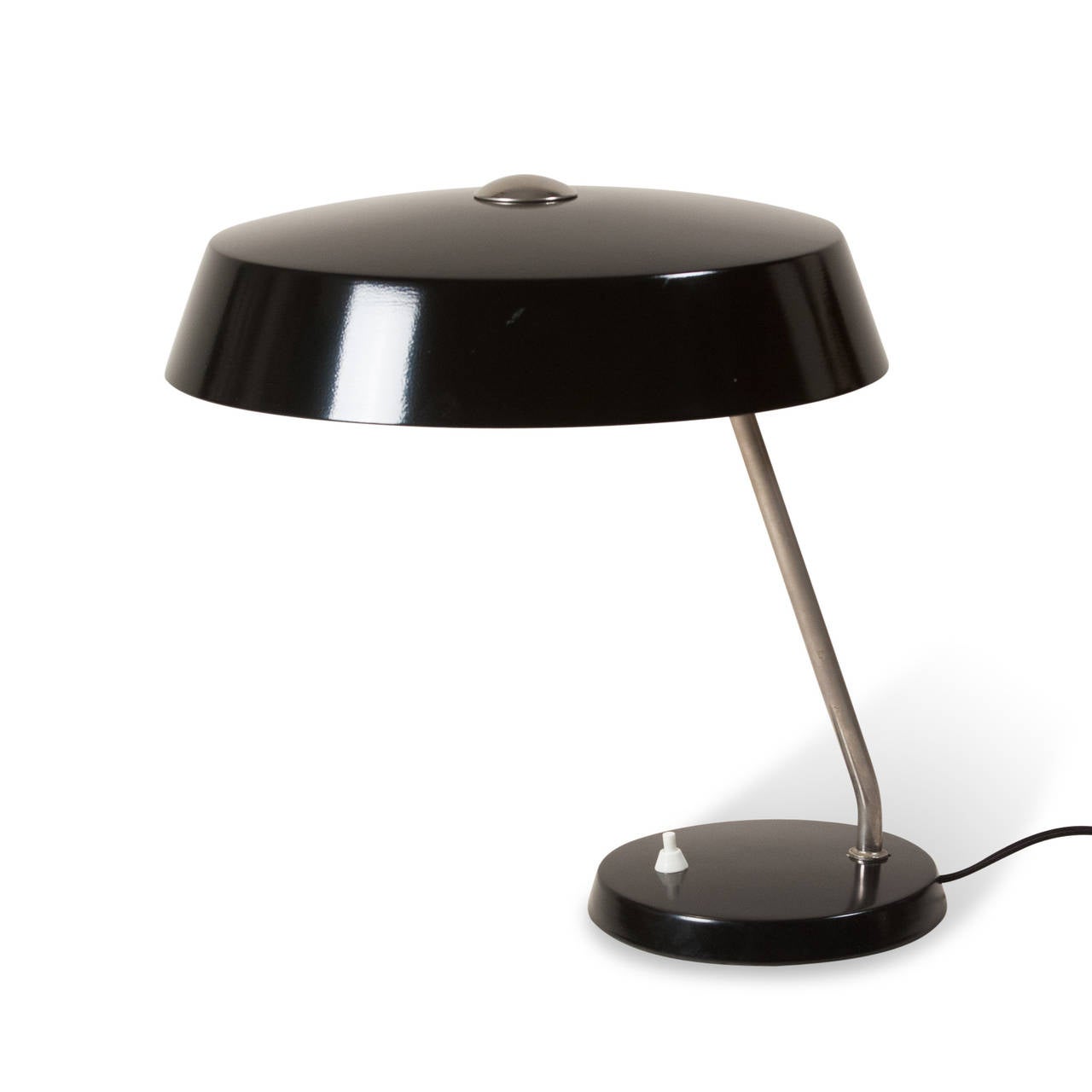 Black lacquered desk lamp, circular dome shade mounted on circular base, German, 1950s. Overall height 16 in, diameter of shade 12 in, diameter of base 7 in.