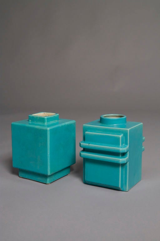 Set of two modernist blue glazed ceramic vases, each based on a cube form, one with stepped base and opening (6 in x 6 in, height 7 in.), and the other with geometric flange flourishes (height 7 in, 5 in x 6 in.), by Robert Lallemant, French circa