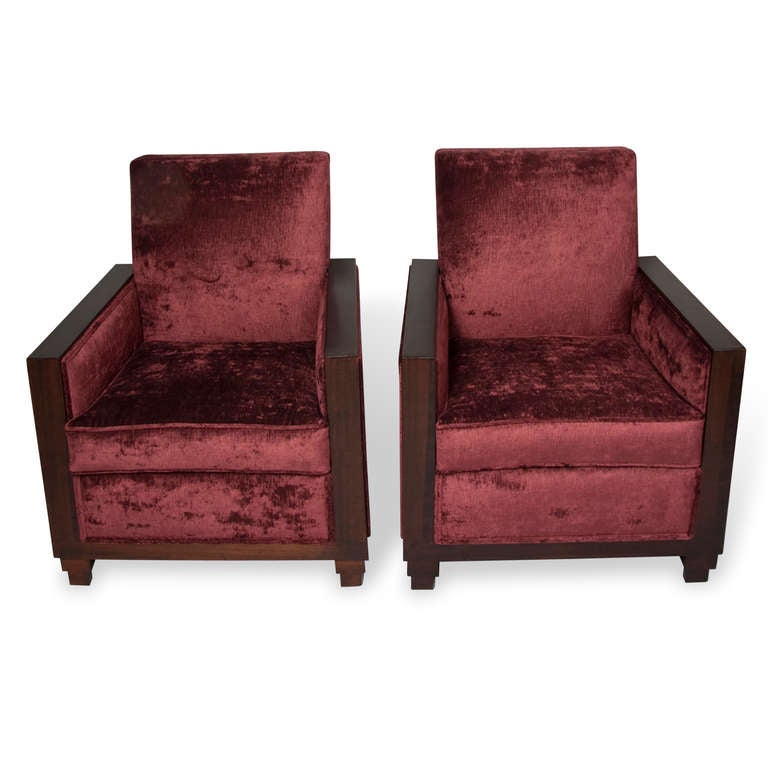 Pair of mahogany frame armchairs, with raised backs, the mahogany wrapping around the entire border of the sides, on stepped bases, French 1930s. Newly upholstered in a deep burgundy velvet blend. Back height 36 in, width 29 1/2 in, depth 25 1/2 in.
