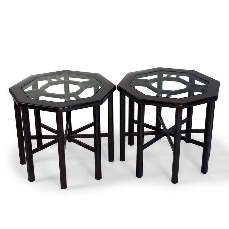 Pair of black lacquered hexagonal eight leg side tables, the top surface inset hexagonal glass,, with intersecting stretches between the legs. American 1950s. 17 in x 17 in, height 15 in. (Item #1791)