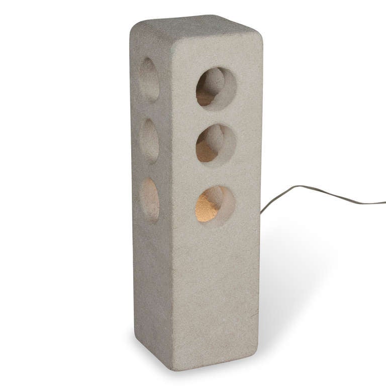 Sculpted stone column lamp, the rectangular form having three circular openings on each side, by A. Tormos, French circa 1970. Signed 