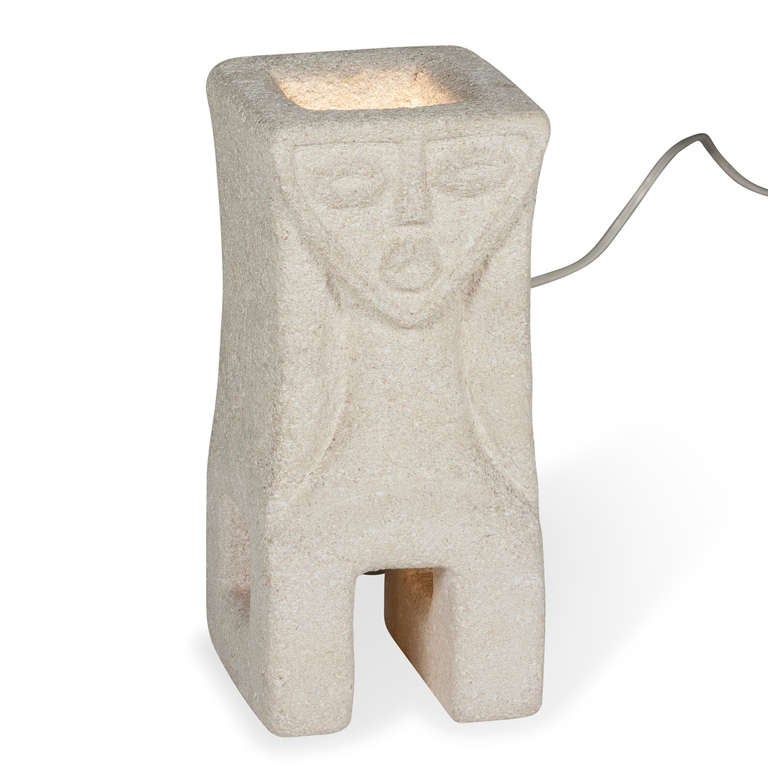 Sculpted stone figural lamp, the overall rectangular form having a carved face in front, with lsquare opening eg type structures on either side, by A. Tormos, French circa 1970. Signed 
