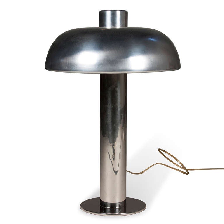 Polished aluminum dome shade desk lamp, offset shade, not centered on the column, and on a chrome column and circular base, by Laurel Lamp Co., American 1960s. Height 18 in, diameter of shade 12 in, diameter of base 6 in. (Item #2067)