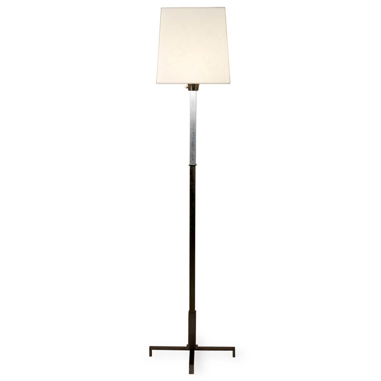 Cruciform base polished steel floor lamp, having a square column and base, the top section polished solid aluminum, in custom square shade, French, circa 1970. Overall height to top of shade 72 in. Shade measures top 12 in square, bottom 14 in