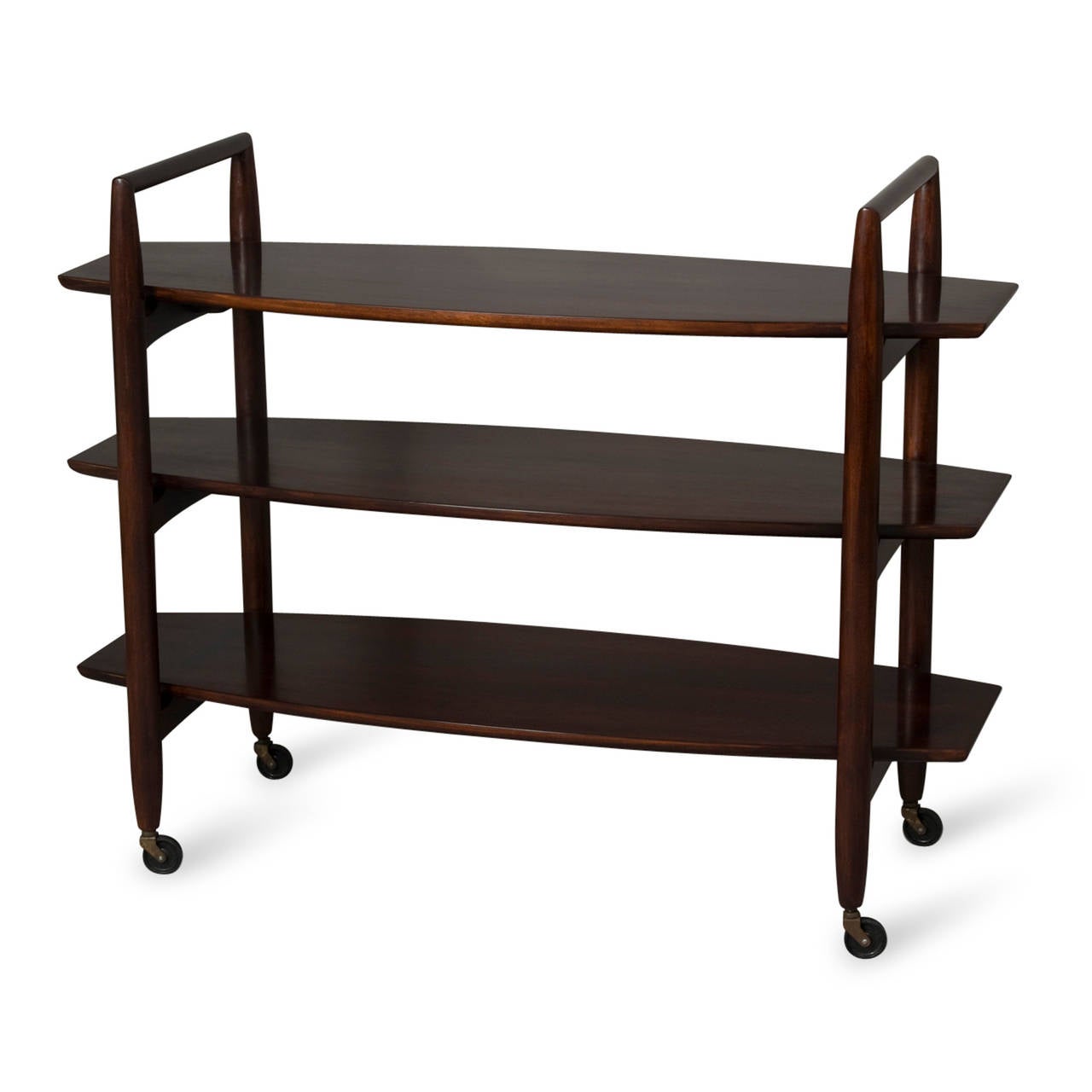 Three-tier mahogany rolling shelf, slightly oval-shaped shelves, inverted U-shaped supports, by T.H. Robsjohn-Gibbings for Widdicomb, American, 1950s. Length 46 in, depth 16 in, height to top shelf 30 in, height to top of arm 35 1/2 in. (Item #2132)