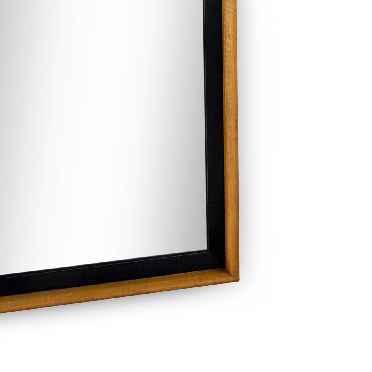 Deep frame two-tone rectangular mirror, in a medium maple with ebonized recess, by Paul Frankl for Johnson Furniture, American, 1950s. Dimensions: 51 in x 31 in, depth 2 in.
