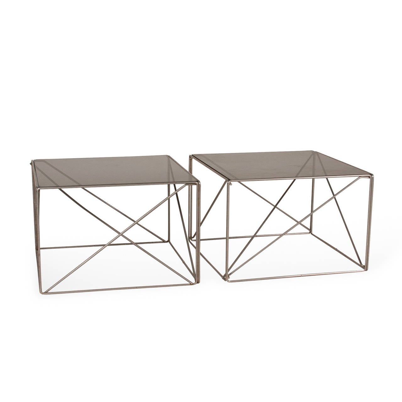 Pair of chrome rod frame end tables, the rods arranged in various intersecting triangles, with smoky grey glass top, by Max Sauze for Rouve, French, circa 1970. 17 1/2 in square, height 12 in. (Item #2267)

Can also be used side by side as a