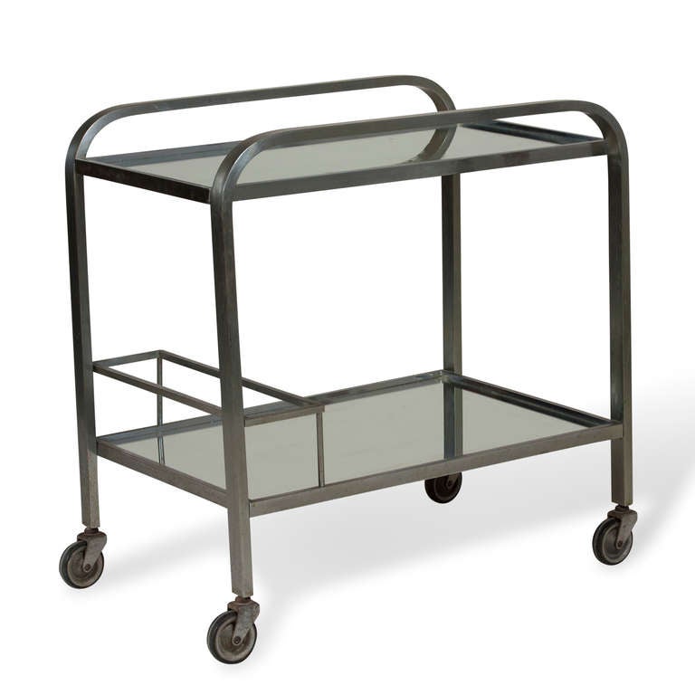 Mirrored two tier serving cart, chrome frame, raised rail handles and lower bottle storage area, on casters. French 1930s. W 16 in x L 25 1/2 in
H 26 in. (Item #2120)