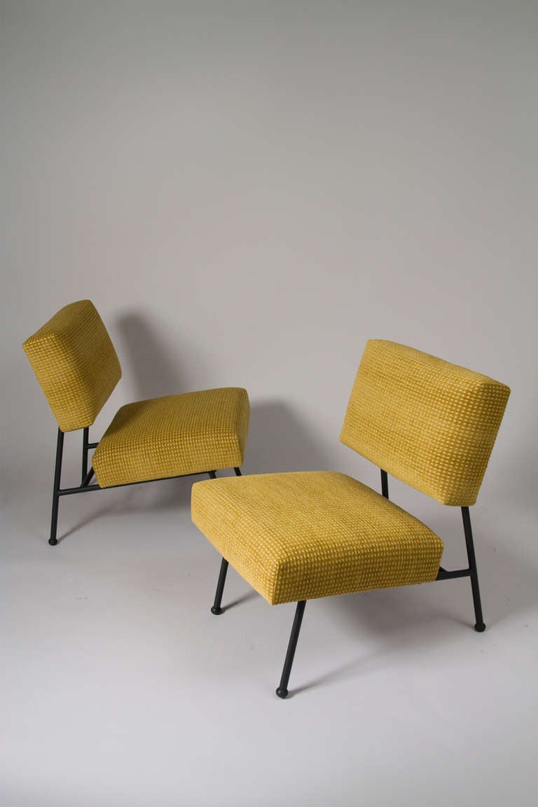 Pair of French modern upholstered chairs, the seat and back on an black lacquered iron frame, with original rubber feet, by Pierre Guariche for Airborne, French 1960. Back height 28 1/2 in, width 22 3/4 in, depth 25 1/2 in, seat height 17 1/2 in.