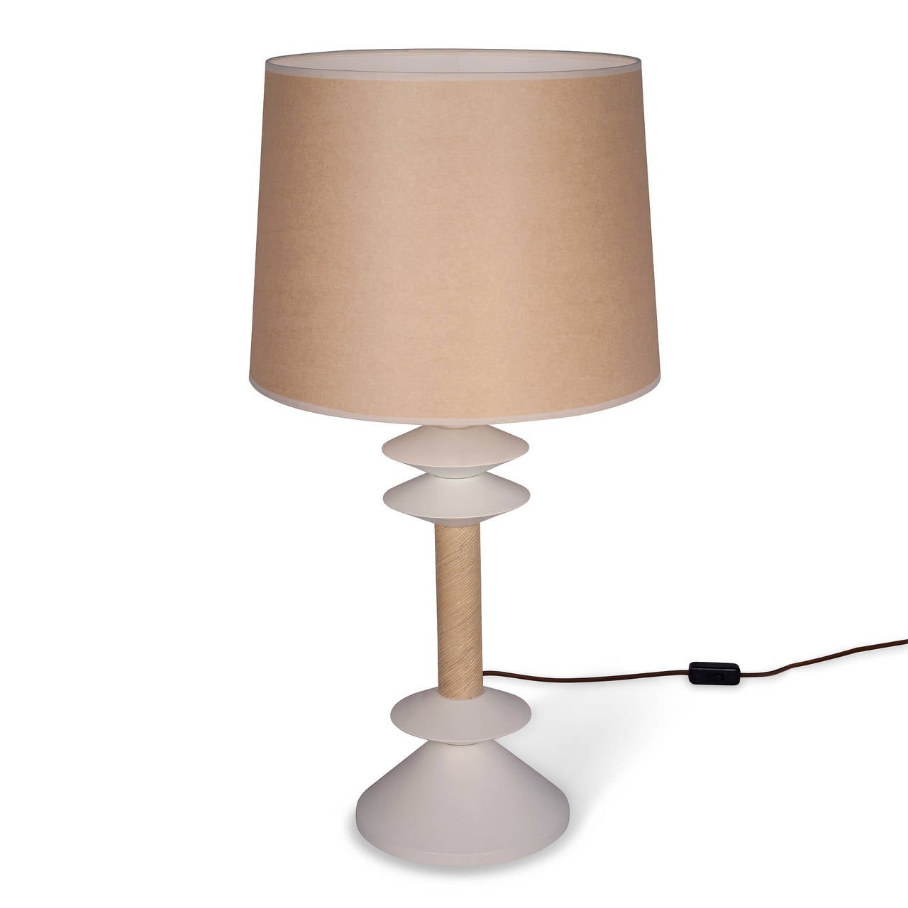 White lacquered steel table lamp, disc shaped elements separated by a reed wrapped middle column section. Designed by Jay Spectre for Paul Hanson, circa 1980. Overall height 31 1/2 in, bottom of base 9 in diameter, discs 6 in diameter. Shade