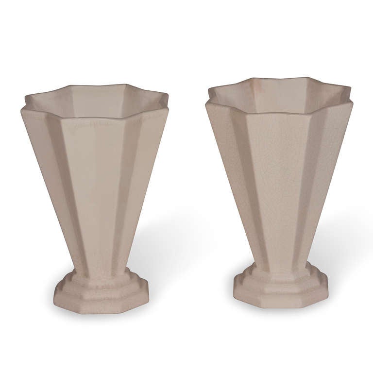 Pair of cone shaped off-white crackle glaze ceramic vases, the cone having numerous folds, and resting on a stepped base, French 1930s. Height 10 in, distance across at top 7 1/4 in, at bottom 5 in. (Item #1970)