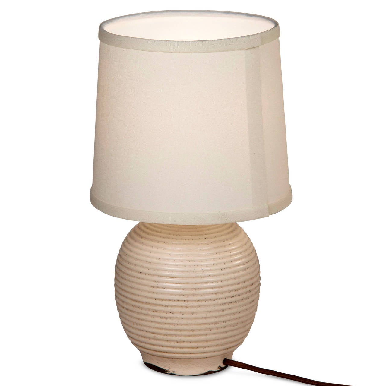 Glazed bulbous form ceramic table lamp, with circular grooves around the body, in custom silk shade, in pale off-white glaze, by Keramos for Sevres, French 1950s. Signed to underside. In custom silk shade. Overall height 14 in, diameter of base 6