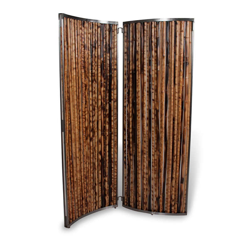 Steel frame two panel room divider, each panel gently arced, vertical bamboo pieces forming the face of the panel. American late 20th century.