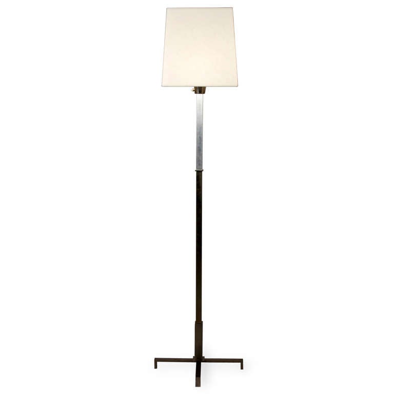 Cruciform base polished steel floor lamp, having a square column and base, the top section polished solid aluminum, in custom square shade, French circa 1970. Overall height to top of shade 72 in. Shade measures top 12 in square, bottom 14 in