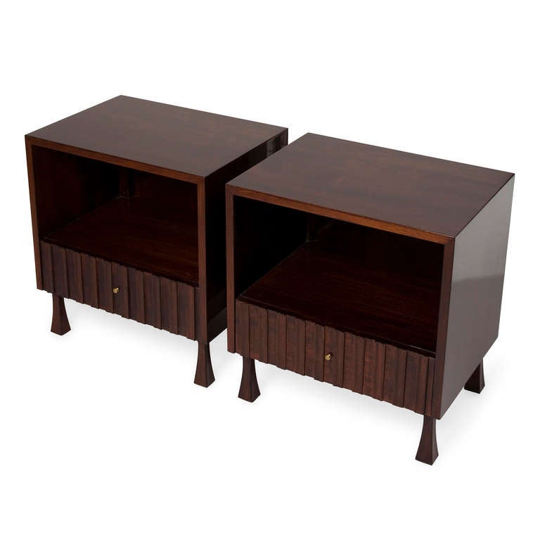 A pair of single drawer mahogany end tables, with open storage compartment above the drawer, the face of the drawer fluted and having a brass pull, the case resting on inverted tapered legs, by Widdicomb, American, 1970s. Width 22 in, depth 16 in,