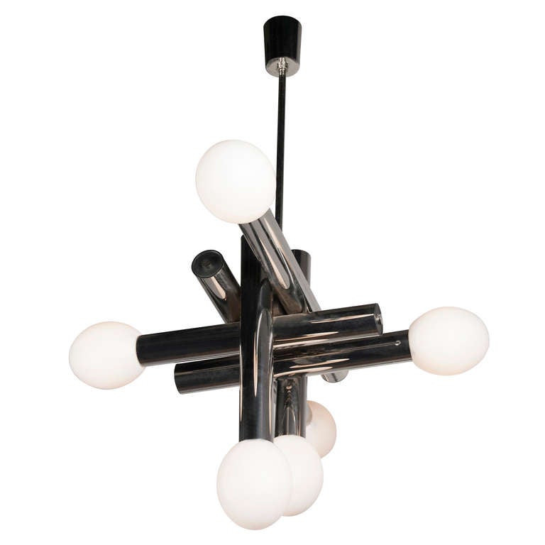 Six-light chrome chandelier, crossed large long chrome cylinders each terminated with an ovoid shaped opal glass diffuser, French, circa 1970. Overall height 36 in, height of fixture 22 in, length 34 in, width 26 in. Each opaline glass piece