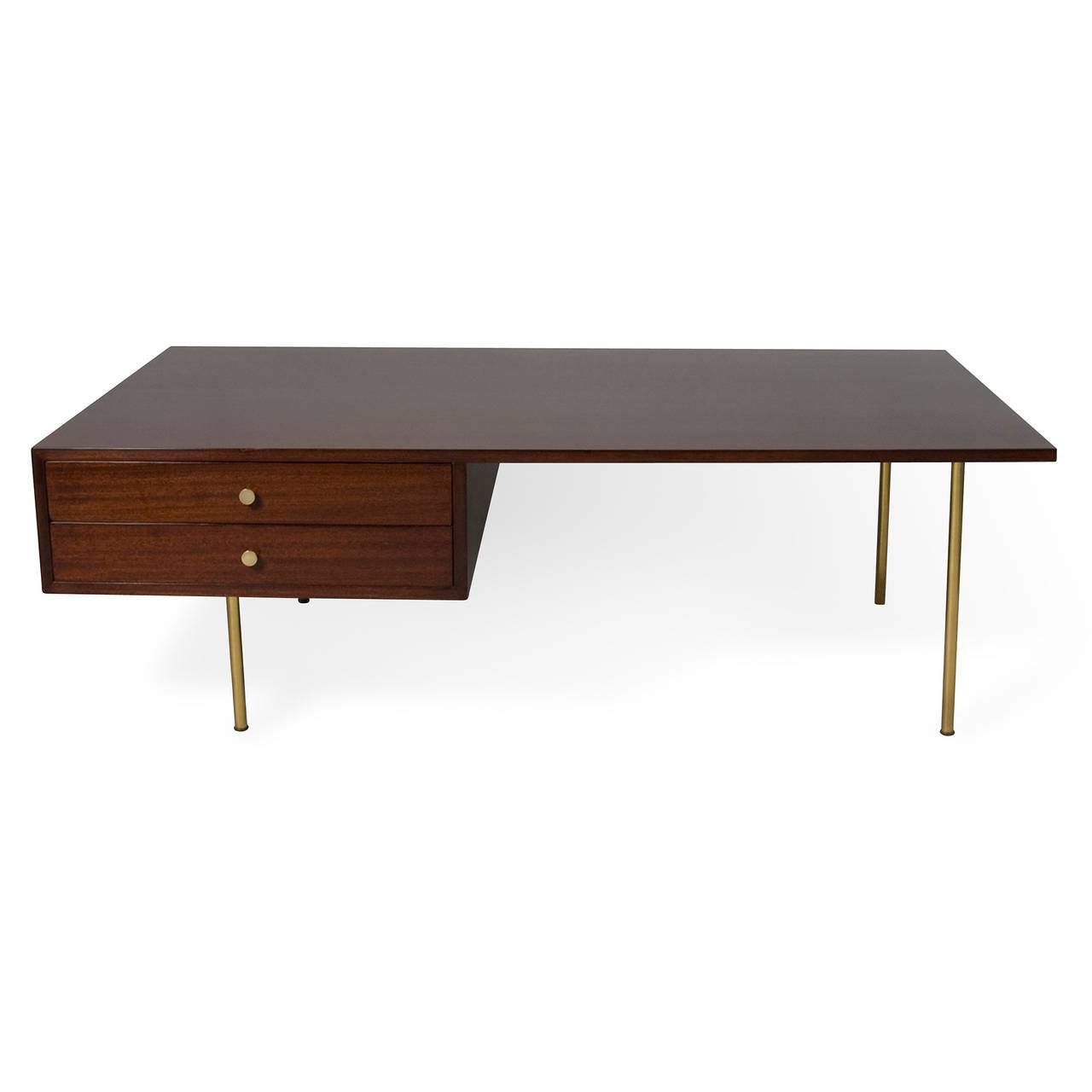 Solid mahogany rectangular coffee table, with two offset drawers having brass pulls, raised on four brass legs. Finished on all four sides. By Harvey Probber, American, 1950s. Measures: 56 in x 32 in, height 18 in.
