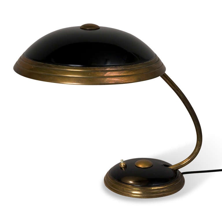 Patinated brass and black lacquered metal dome desk lamp, the shade as well as the arm pivoting up and down, by Helo, German, 1930s. Height 14 in, diameter of shade 12 1/4 in. (Item #2129).