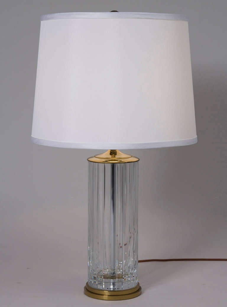 Lead crystal simple fluted column table lamp with brass base and cap, in custom silk shade, by Baccarat, French 1960s. Acid etched signature. Overall height 25 3/4 in, diameter of base 5 1/2 in. Shade measures top diameter 13 in, bottom diameter 15