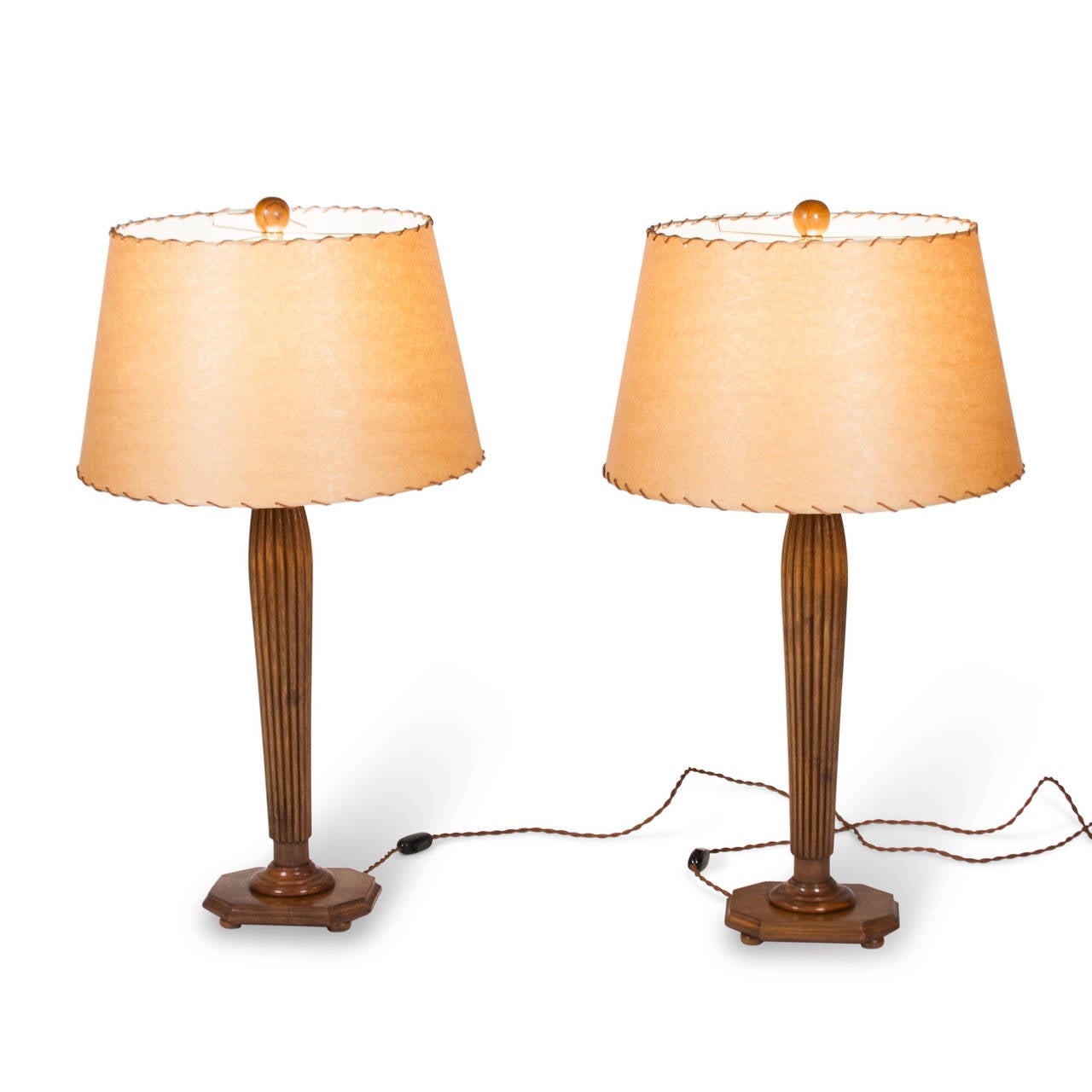 Pair of fluted and tapered column fruitwood table lamps, the column resting on rectangular base with ball feet, in custom stitched parchment paper shades, and having wood ball finial, Italian 1960s. With paper label to underside from Rome gallery.