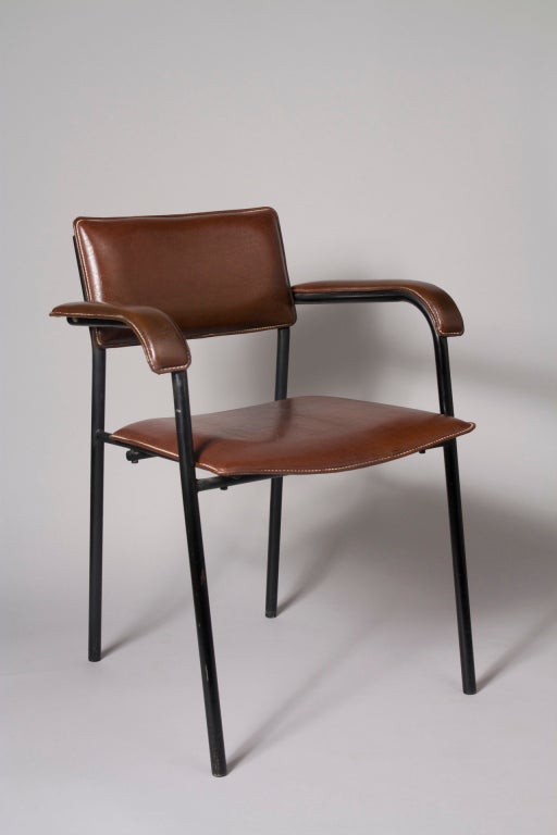 Burgundy handstitched leather upholstered black lacquered iron frame open armchair, the arm rests as well as the seat and back upholstered, by Jacques Adnet, French 1950. Back height 30 in, seat height 17 1/2 in, arm height 25 1/2 in, width 23,