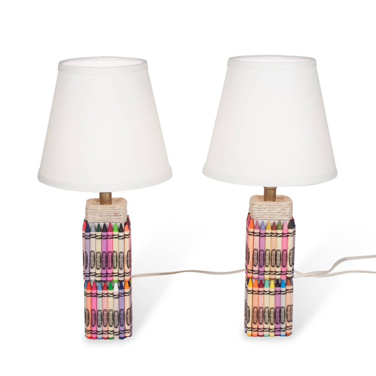 Pair of crayon table lamps, square ceramic form with Crayola brand crayons of assorted colors applied to surface, with wrapped rope at top of base, in custom linen shade. American 2000s. Overall height 16 1/2 in, base is 3 in square. Shade measures