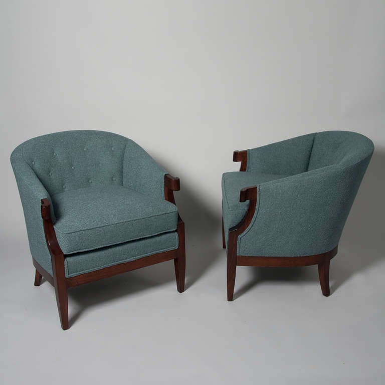 Pair of mahogany frame upholstered armchairs, the end of arm having a curved end flourish, loose seat, button tufted back, upholstered in a cotton blend boucle by Kravet, by Baker, American 1950s. Back height 30 1/4 in, width 29 in, depth 30 in.