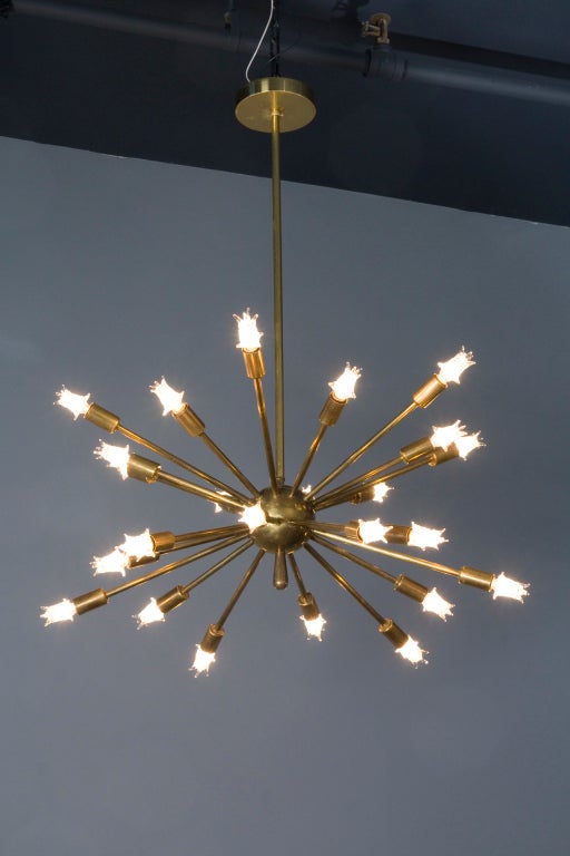 Brass sputnik style 24 arm chandelier, the rays emanating from a center sphere, Italian 1960s. Diameter 24 in, overall height as configured 34 in, height of fixture only 14 in. (Item #1504)