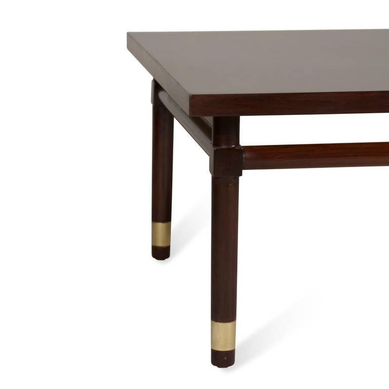Solid mahogany square coffee table, rounded legs with brass band elements near the bottom, round stretchers between the legs, by Widdicomb, American, 1950s. 31 in square, height 16 1/2 in. (Item #2139)