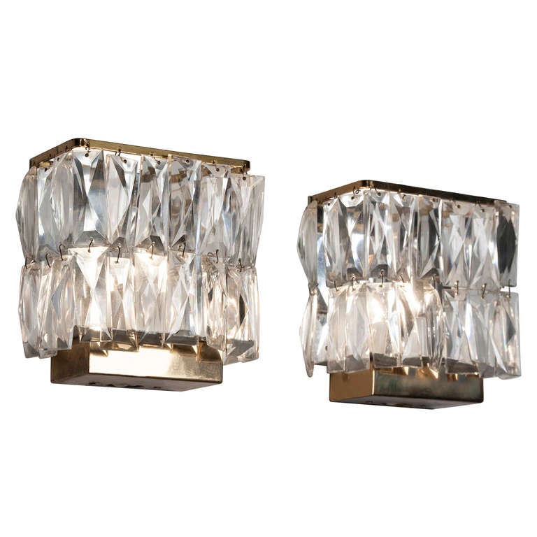Pair of faceted crystal and brass wall sconces, of overall rectangular form, the face two rows of crystals, and having further crystals on either side, with brass top and bottom caps. French 1960s. Height 6 1/4 in, width 5 5/8 in, depth 3 in. (Item