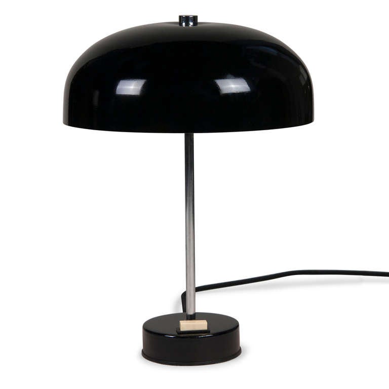 Black lacquered desk lamp, lacquered dome shade mounted on a thin chrome column, with a disc shaped circular base, original toggle switch. German circa 1970. Overall height 14 in, diameter of shade 10 in, height of shade 4 in, base measures 4 in