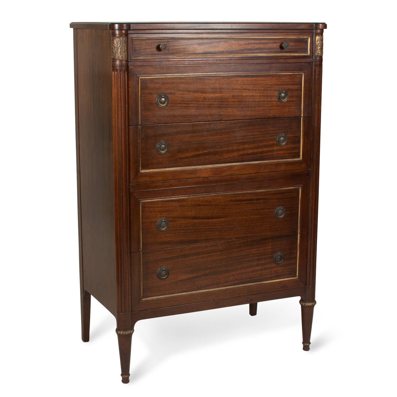Art Nouveau five-drawer tall chest in mahogany, gilt decorated drawer faces, gilt floral corner elements, fluted column, tapered legs, aged brass drawer pulls, by Widdicomb, American, circa 1910. 33 x 20 inches, height 62 in. (Item #2225)