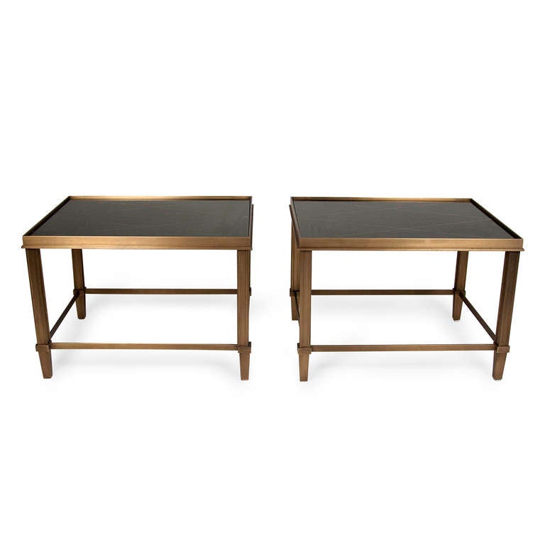 Bronze frame end tables, with ebonized rectangular tops having gold diamond pattern decoration, straight column legs with slight taper at foot, stretchers joining each leg, Italian 1960s. Height 18, width 20 1/2, depth 26 in. Very heavy and solid.