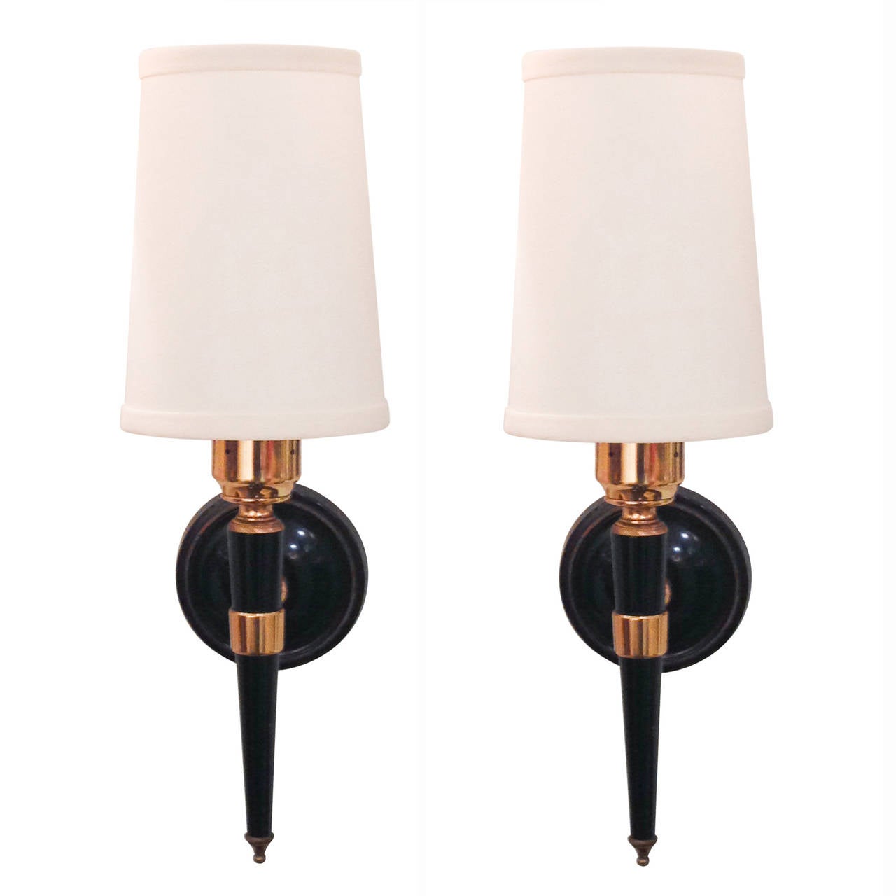 Pair of black lacquered and brass post sconces, single light, the post mounted on a circular wall mount, French, circa 1960. In custom silk shades. Overall height 13 in, width 5 in, depth 6 in. Diameter of backplate 3 1/2 in. Shades measure top