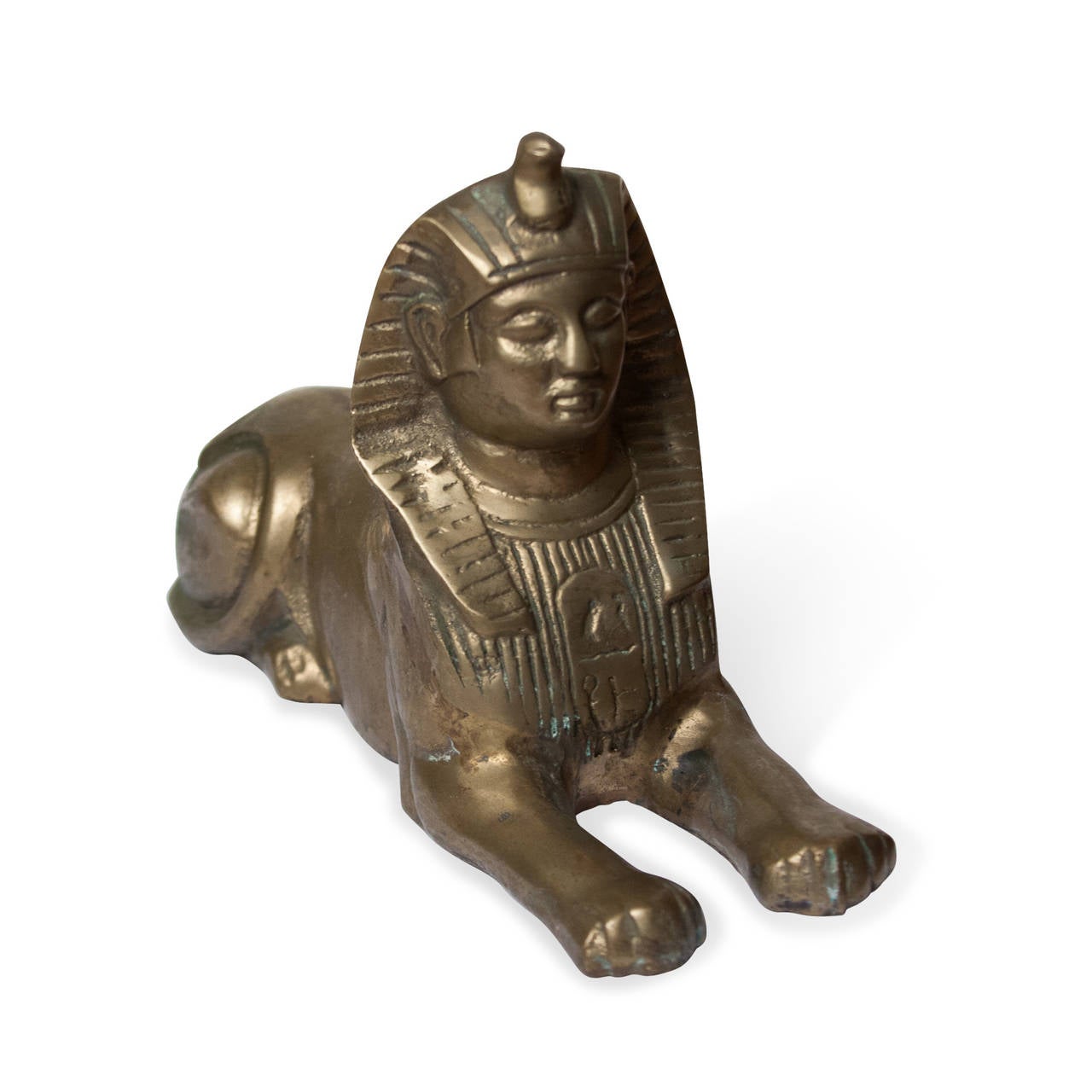 Brass sculpture of a sphinx, American, 1960s. Length 9 in, width 3 in, height 5 1/2 in.

Condition: some oxidation.