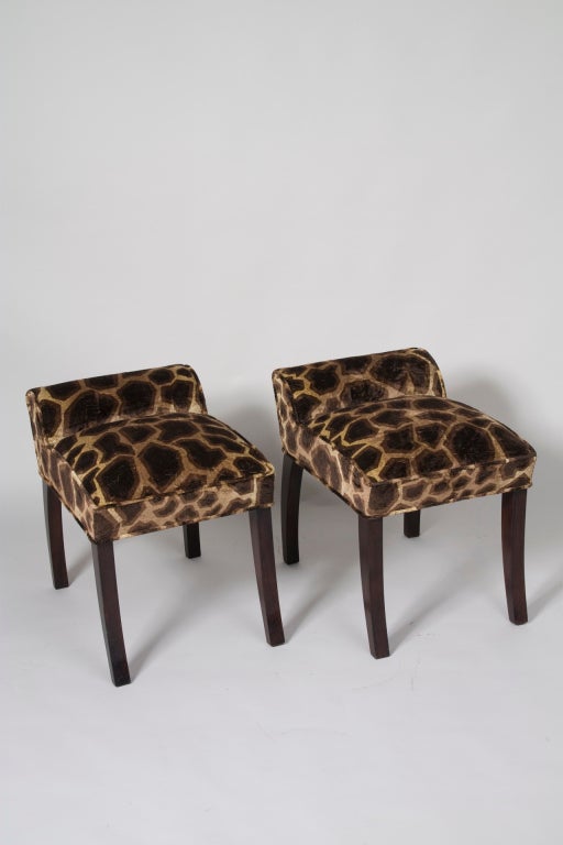 Pair of curved back stools, with gracefully arced brown mahogany legs, the seat rising slightly in the center, with a short back, by Paul Frankl, American, 1930s. 16 x 20 in, height 21 in, seat height 17 in. Upholstered in a Kravet animal print